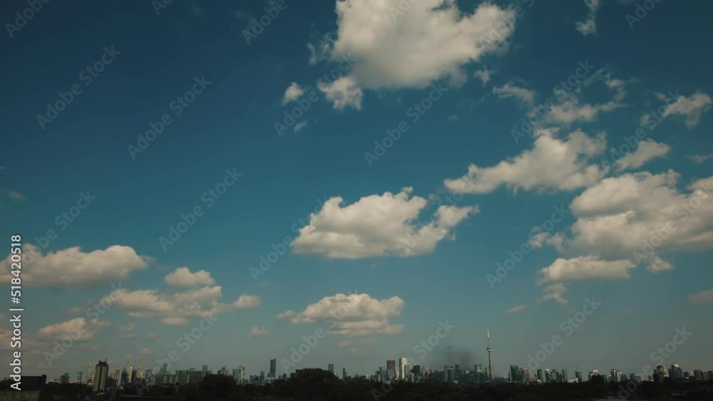 Extreme ultra wide view of the Toronto skyline on a day with puffy clouds. Shot in 4K RAW on a cinema camera. Extreme ultra wide view of the Toronto skyline on a day with puffy clouds. Shot in 4K RAW on a cinema camera.