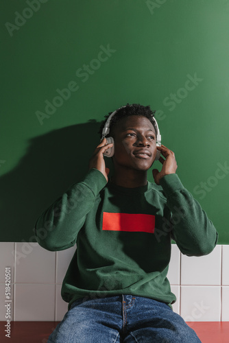 A handsome guy enthusiastically listens to music with headphones