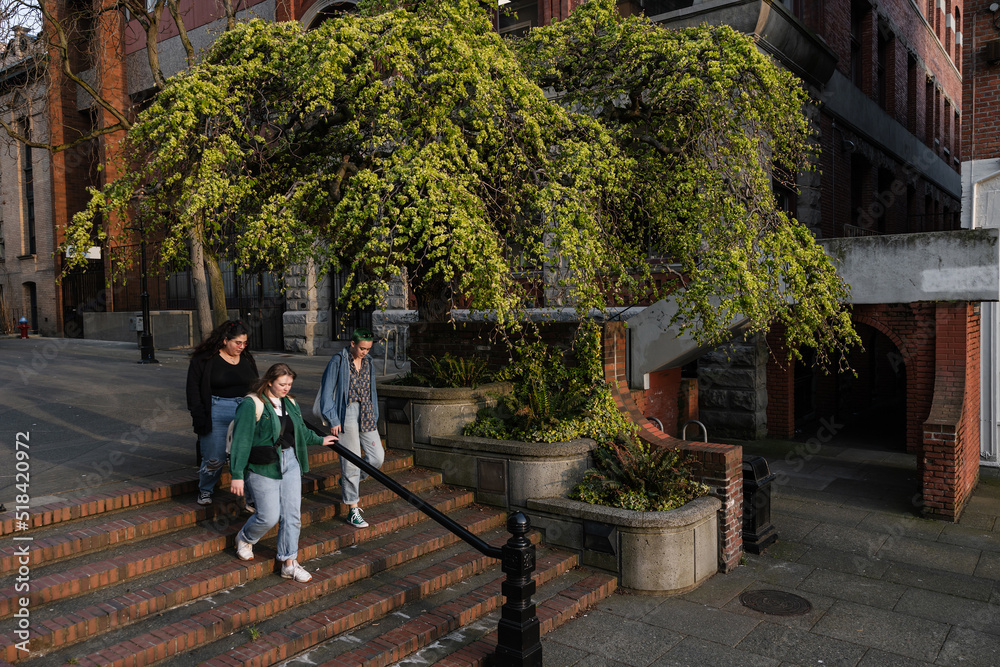 Three women walking in town square. Three women walking in town square.