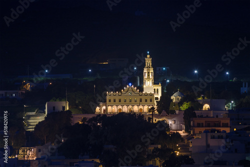 Night long exposure view of Tinos town. Centered the famous church of Panagia, Virgin Mary, illuminated at night. Tinos island Cyclades, Greece.