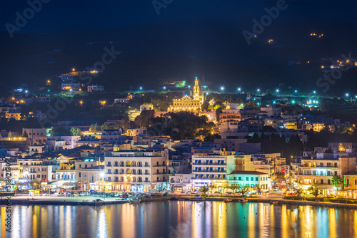 Night long exposure view of Tinos town. Centered the famous church of Panagia, Virgin Mary, illuminated at night. Tinos island Cyclades, Greece.