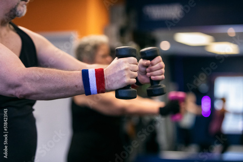 Man Using Weights During Workout Class photo