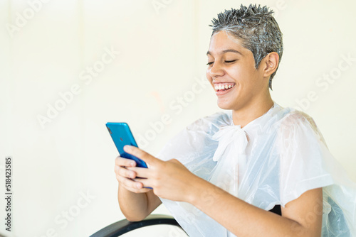 Young woman in the beauty salon in the process of hair bleaching 
