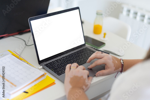 Hands typing on laptop keyboard 
