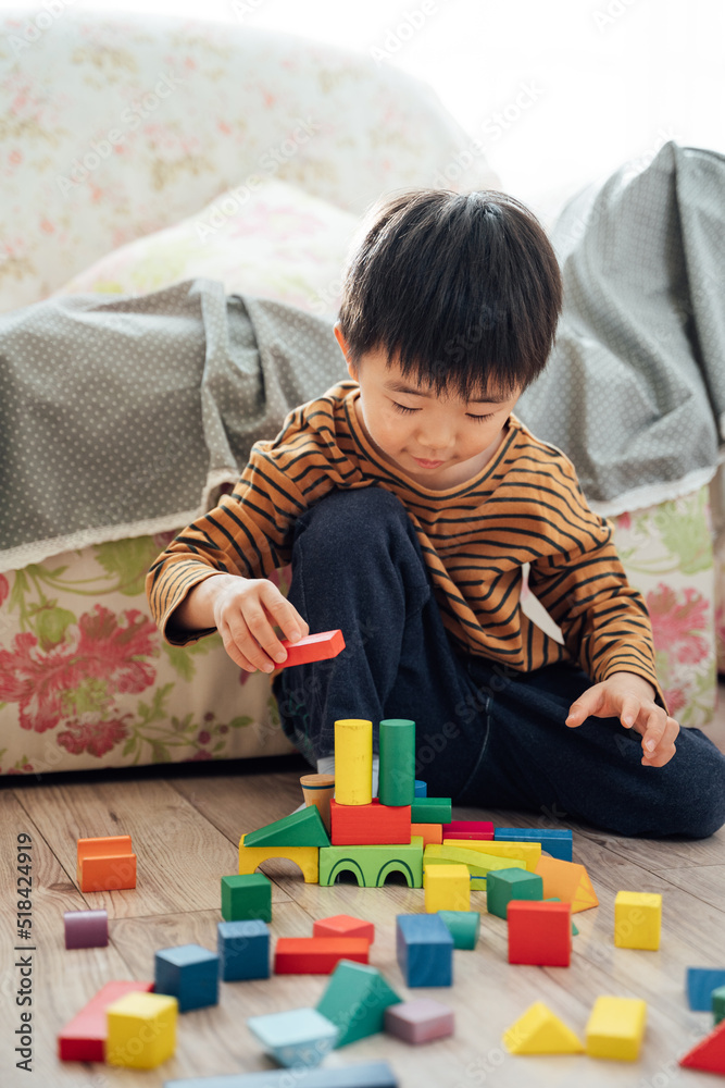 Cute boy playing blocks at home Cute boy playing blocks at home