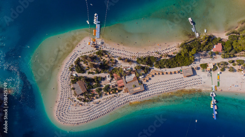 top view of a beach at peninsula - azure water and rows of chairs photo