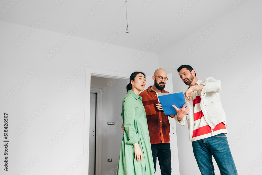 Real Estate Agent Showing Documents to Clients Real Estate Agent Showing Documents to Clients