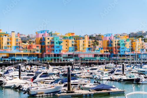 Boats moored in harbor near colorful buildings in Albufeira photo