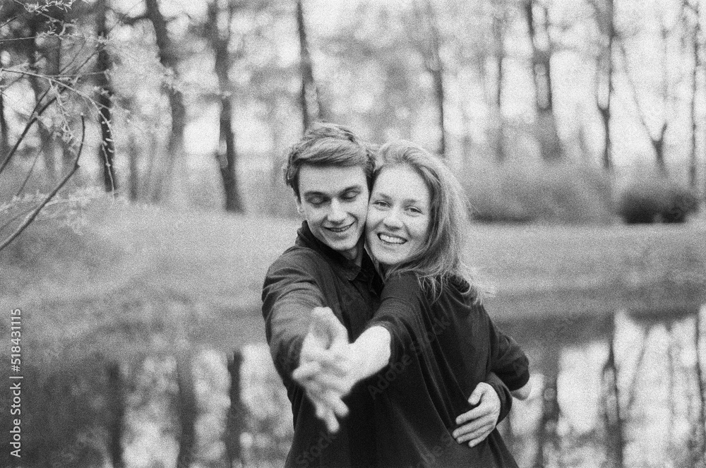 Happy young couple dancing by the lake Happy young couple dancing by the lake