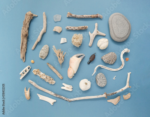 Flatlay on blue of items found on a beach