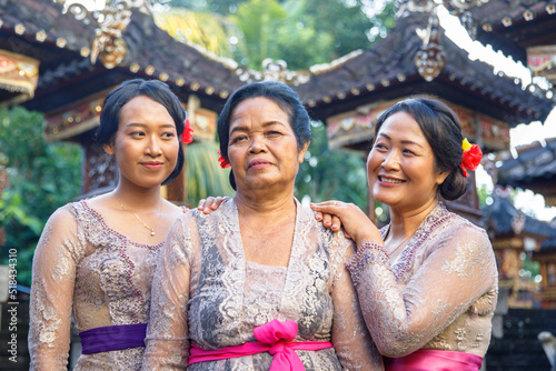 Portrait - three Balinese generations standing together in traditional photo