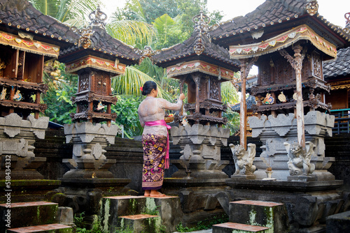 Indonesian woman putting offerings in a temple