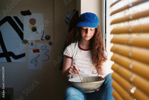 User-generated content freckled teen girl eating in own room