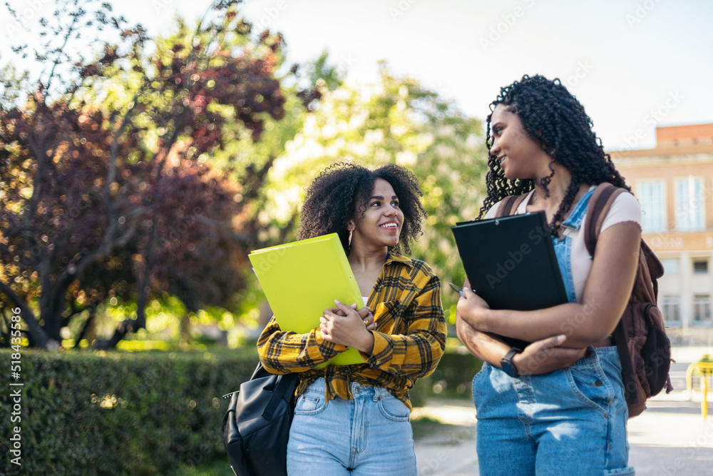 Young students walking outside at university Young students walking outside at university