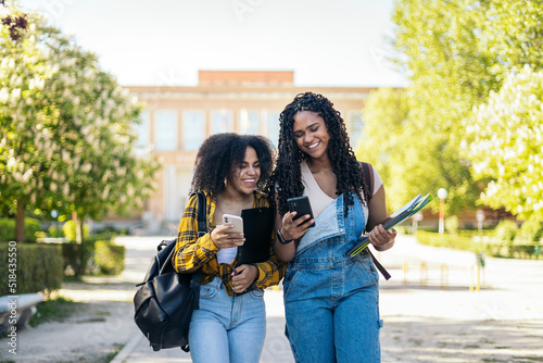 College friends laugh at phone text