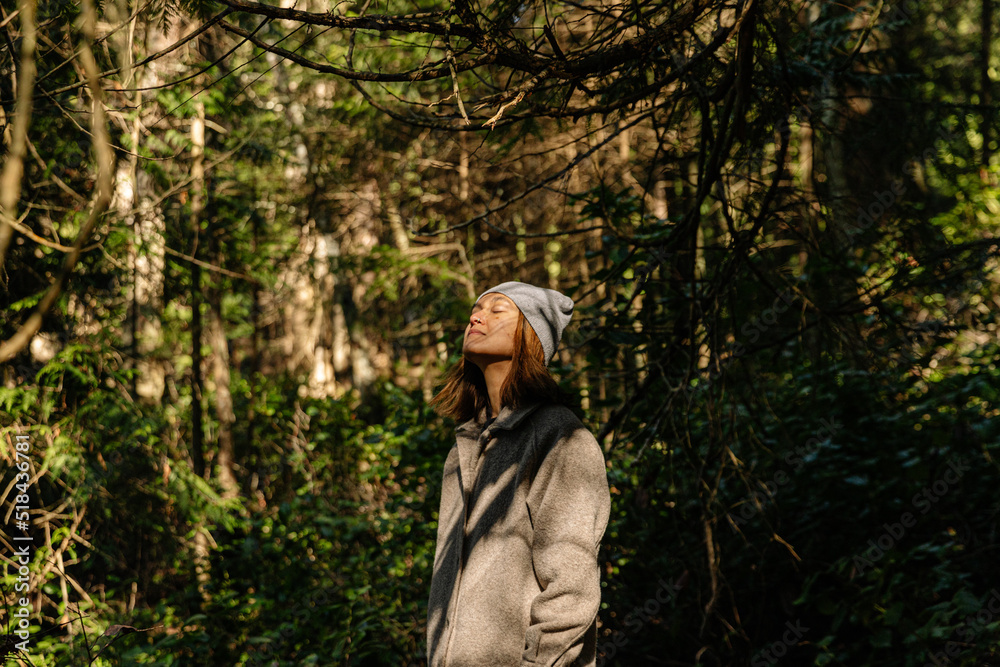 Young woman forest bathing/relaxing in forest Young woman forest bathing/relaxing in forest