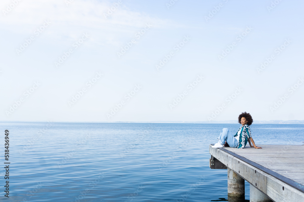Cool woman relaxing on a pier Cool woman relaxing on a pier