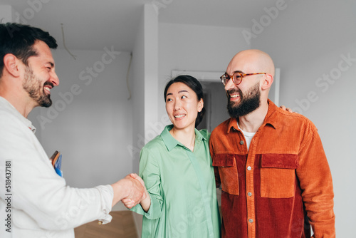 Real Estate Agent Shaking Hands with Clients  photo