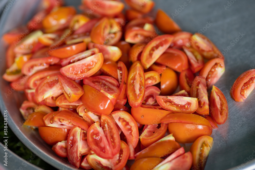 Several halved tomatoes ready to be eaten or used for cooking. Several halved tomatoes ready to be eaten or used for cooking.