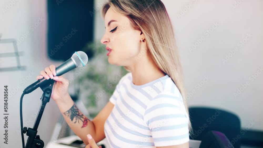 4k beautiful woman singing and playing piano. Emotional female vocalist and musician. Training tutorial in white studio. Rehersal performance voice training. 
