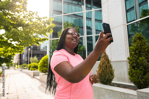 Plus size sportswoman using phone