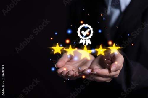 Female hand giving or protect excellent customer satisfaction. with 5 star rating graphic symbols on the screen