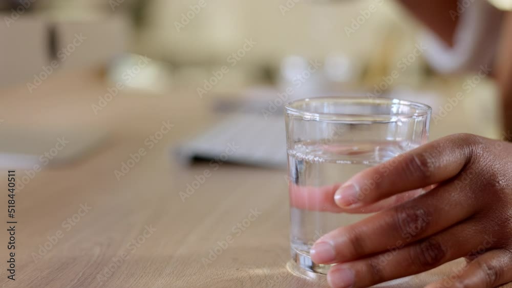 Pouring water for hydration and refreshment. Hands holding bottle and glass with refreshing beverage. Businesswoman feeling thirsty and enjoying an alkaline drink to get daily intake of liquid Pouring water for hydration and refreshment. Hands holding bottle and glass with refreshing beverage. Businesswoman feeling thirsty and enjoying an alkaline drink to get daily intake of liquid