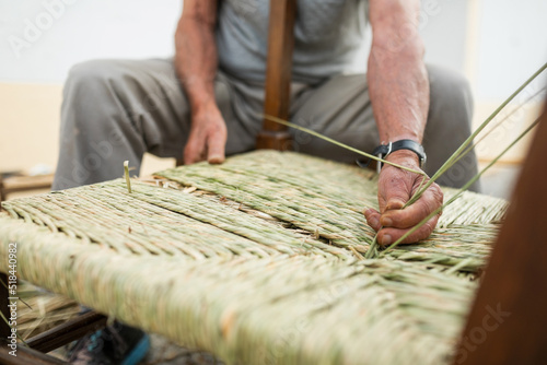 senior craftsman making a chair with bayon photo