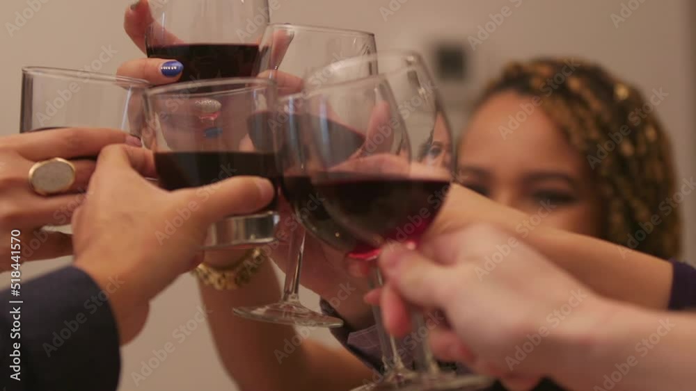 Cheers with wine in Slow motion close up of diverse Group of young professionals having dinner and doing cheers with wine glasses. Cheers with wine in Slow motion close up of diverse Group of young professionals having dinner and doing cheers with wine glasses.