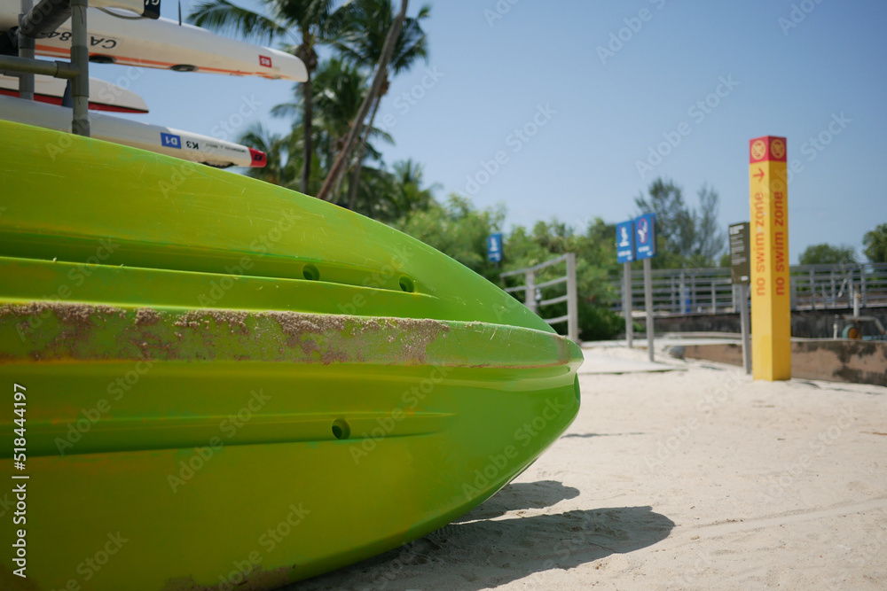 green color surfboard at the beach .
