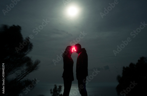Magical portrait of couple about to kiss under moonlight photo