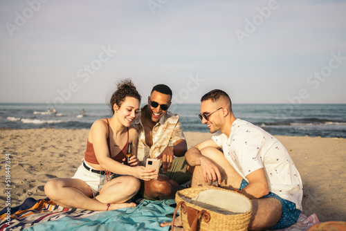 Multiracial group of friends spending the day at the beach photo