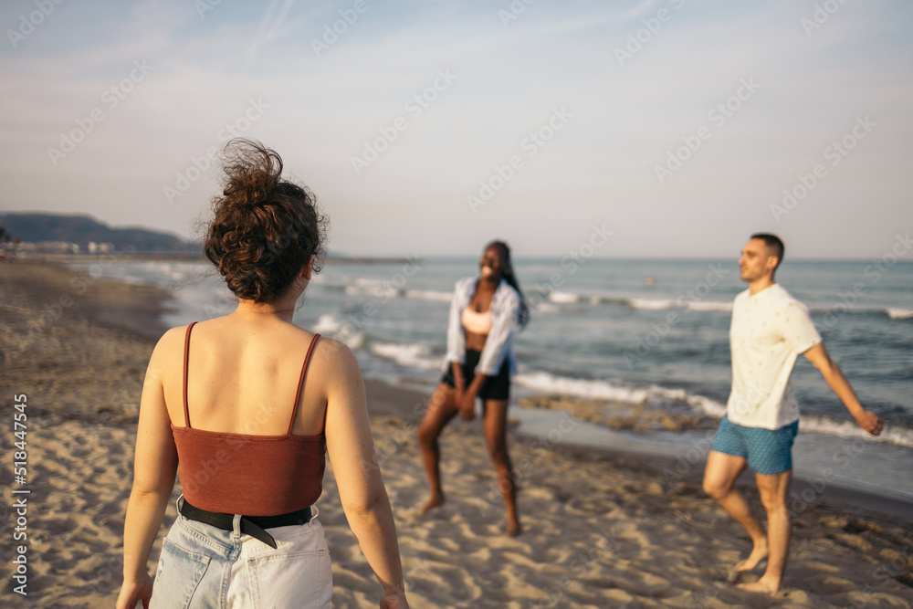 Group of friends playing and enjoying on the beach Group of friends playing and enjoying on the beach