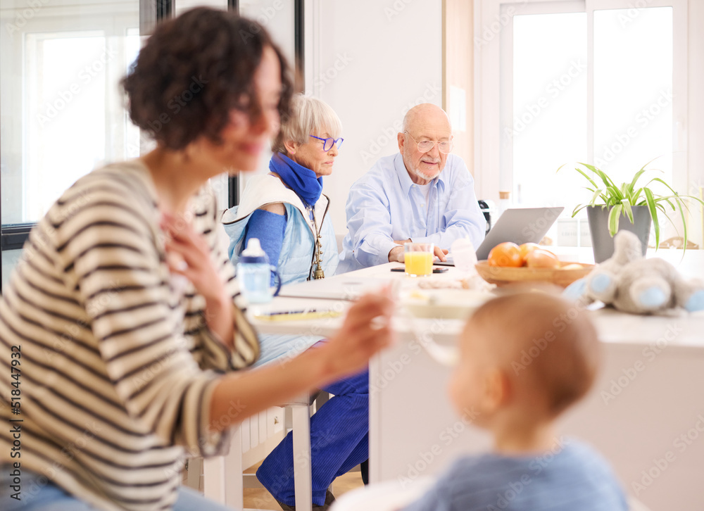 Grandparents using laptop in kitchen Grandparents using laptop in kitchen