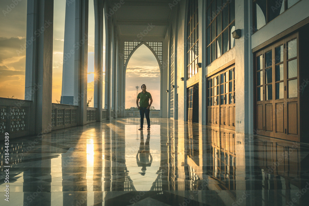 Man in silhoette in area of Central Mosque in Songkhla province, Southern of Thailand. Photo reflection of shadow by polished floor Man in silhoette in area of Central Mosque in Songkhla province, Southern of Thailand. Photo reflection of shadow by polished floor