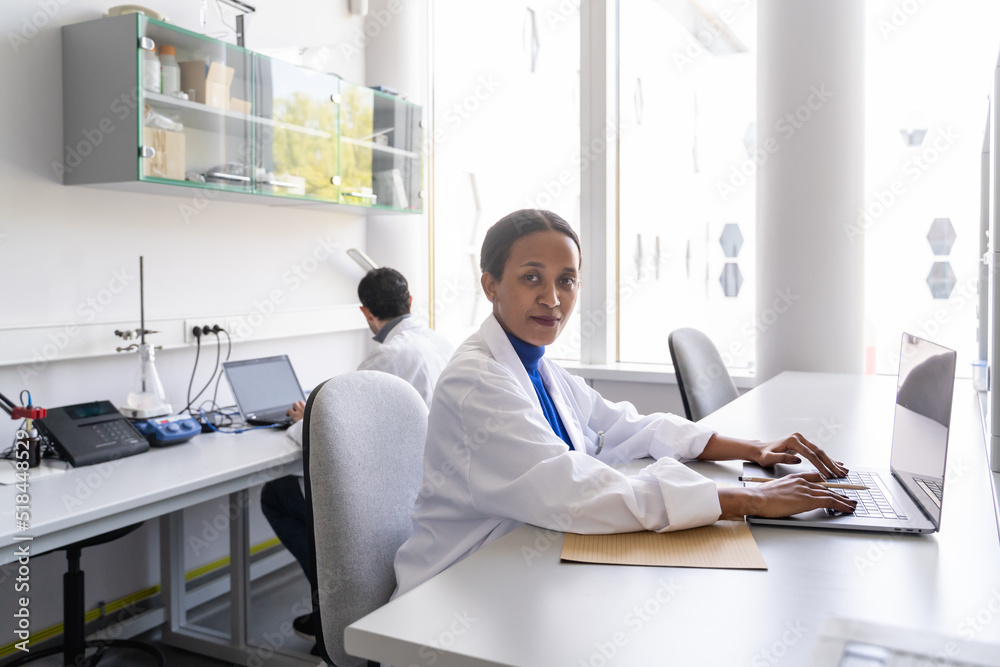 Portrait Of Female Scientist Using Laptop In Lab Portrait Of Female Scientist Using Laptop In Lab