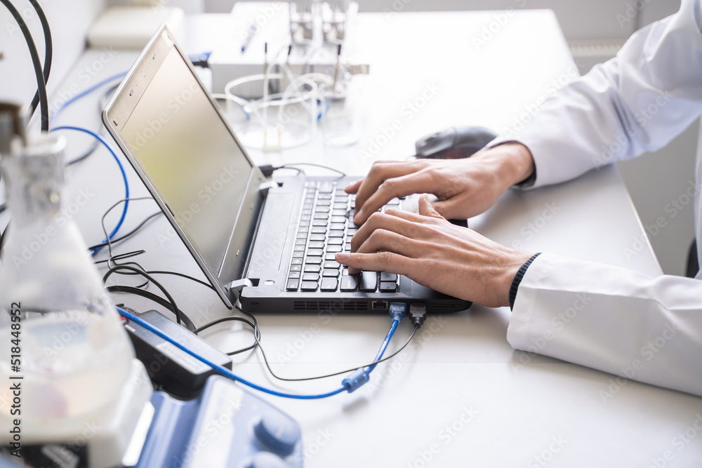 Anonymous Man Using Laptop In Lab Anonymous Man Using Laptop In Lab