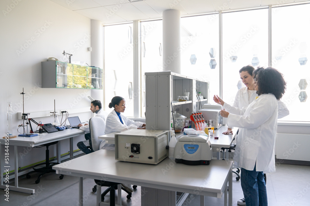 Scientists Working In Bright Modern Laboratory Scientists Working In Bright Modern Laboratory