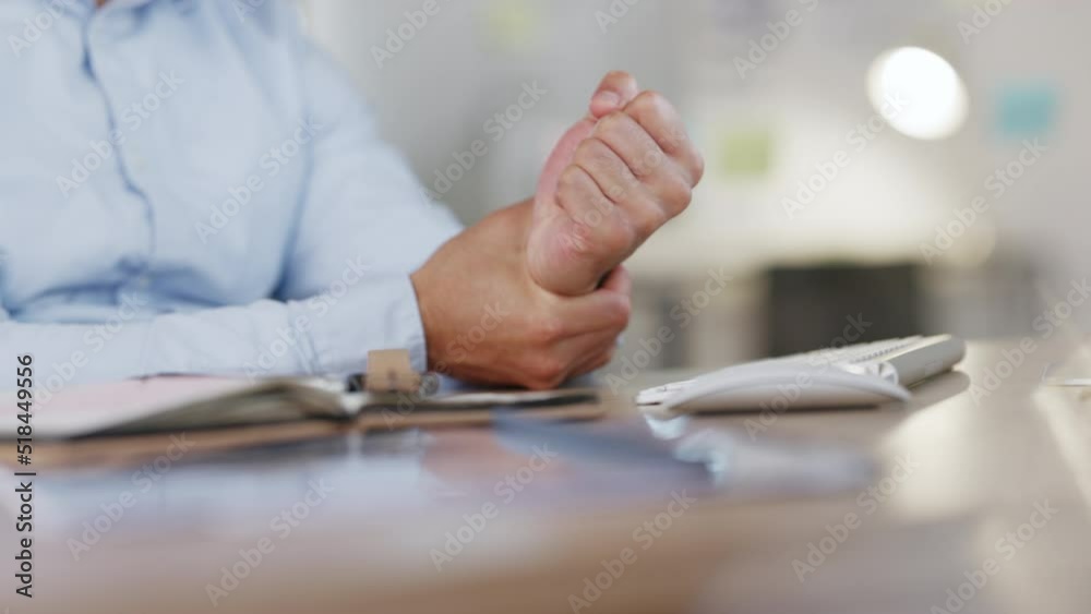 Man with carpal tunnel syndrome removes his watch to massages the ache and numbness in his wrist. Male sitting in office suffering from pinched nerve joint pain after typing on a computer at work Man with carpal tunnel syndrome removes his watch to massages the ache and numbness in his wrist. Male sitting in office suffering from pinched nerve joint pain after typing on a computer at work