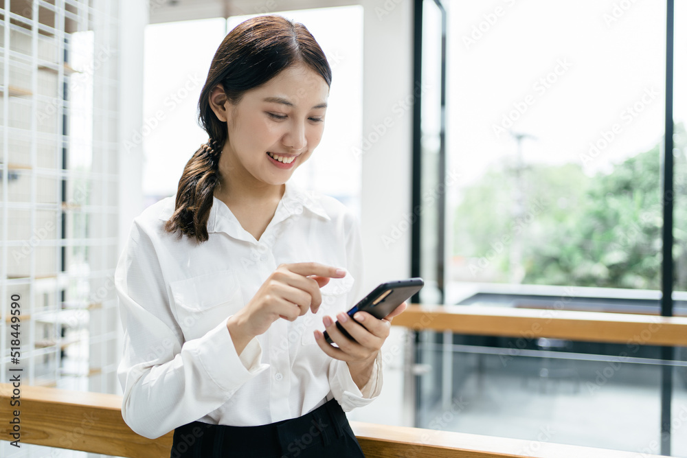 Asian businesswoman in formal suit in office happy and cheerful during using smartphone and working. Asian businesswoman in formal suit in office happy and cheerful during using smartphone and working.