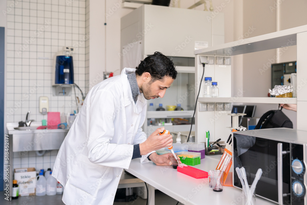 Man Using Pipette In Lab Man Using Pipette In Lab