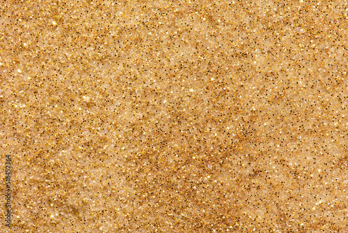 Texture pattern of yellow sand with shiny grains