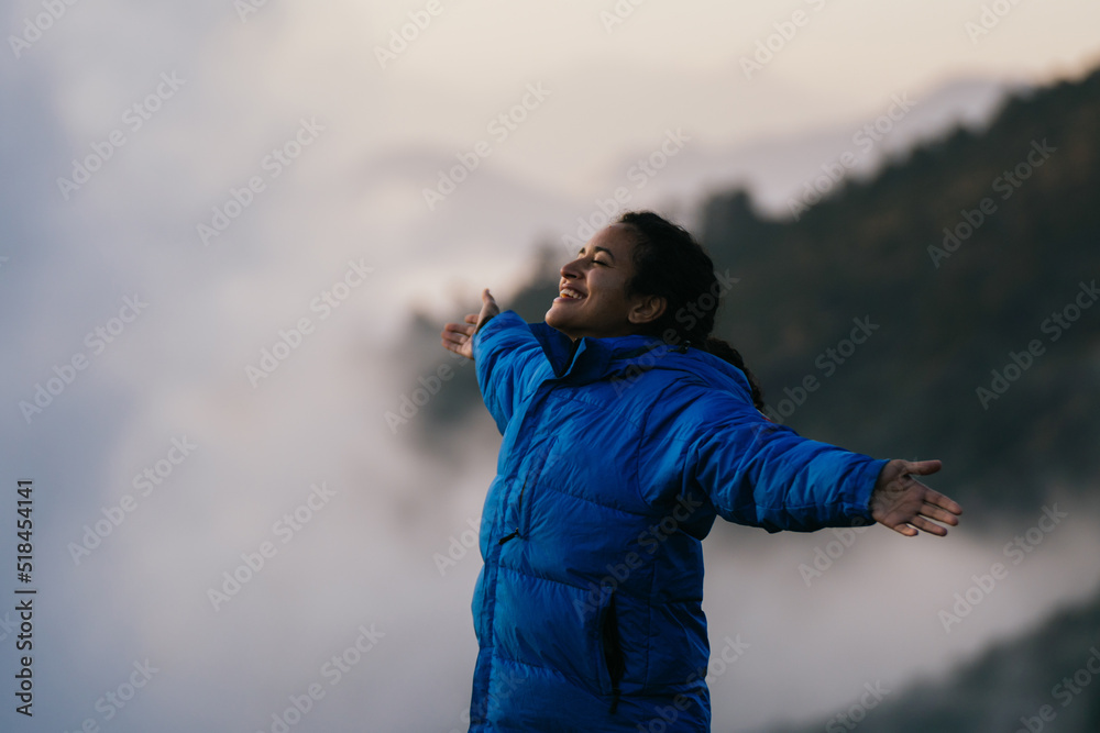 Young woman on top of mountain Young woman on top of mountain