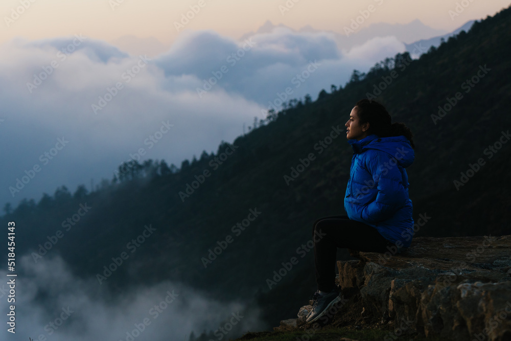 Young woman on top of mountain