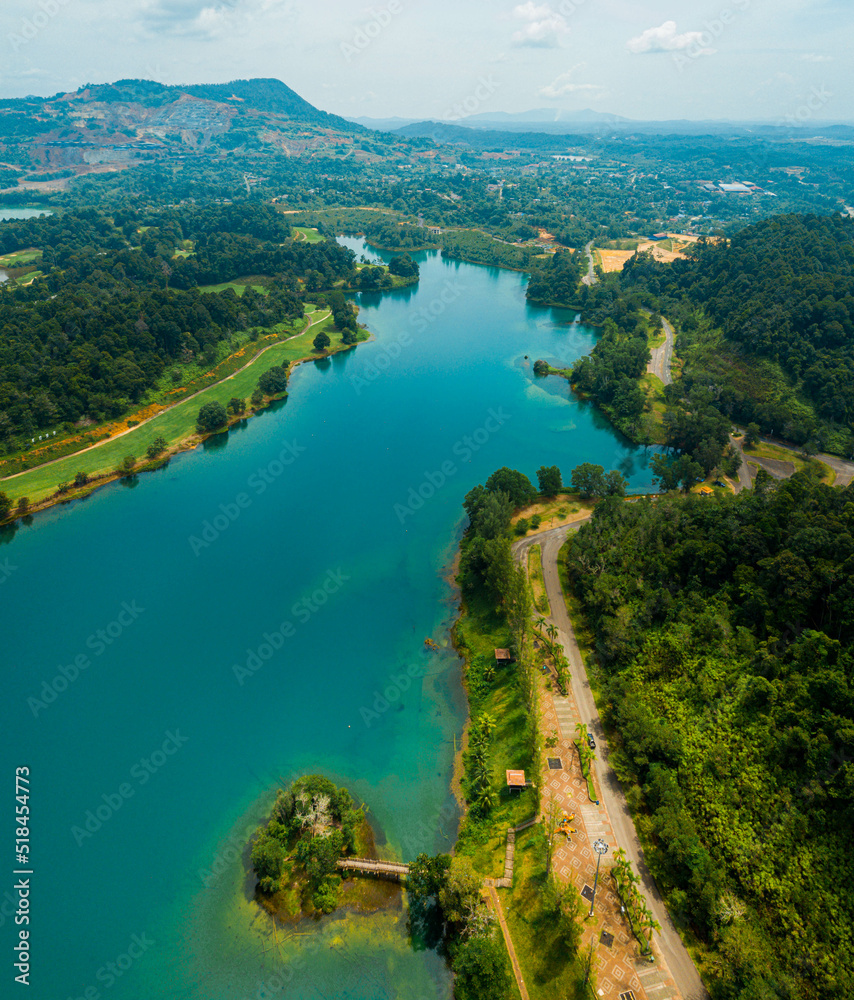 Aerial drone view of lake scenery with turquoise water in Tasik Puteri, Bukit Besi, Terengganu, Malaysia.