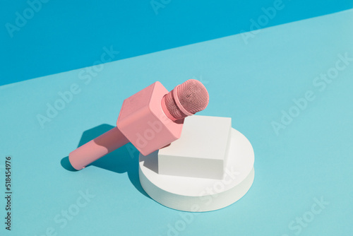 Pink microphone on blue background