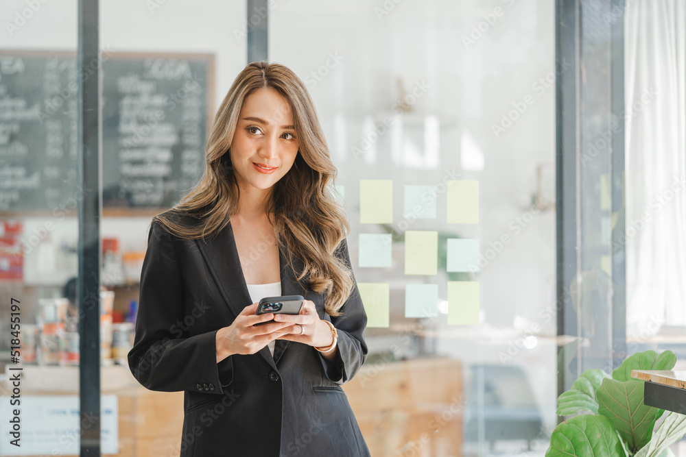 Charming brunette Asian business woman using mobile phone, Pretty Asian lady massaging in cellphone at modern office. Charming brunette Asian business woman using mobile phone, Pretty Asian lady massaging in cellphone at modern office.