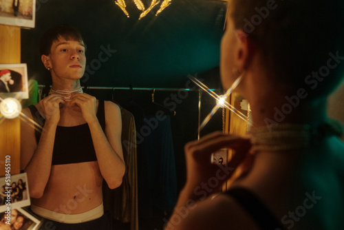 Young Man Trying On Bead Necklace