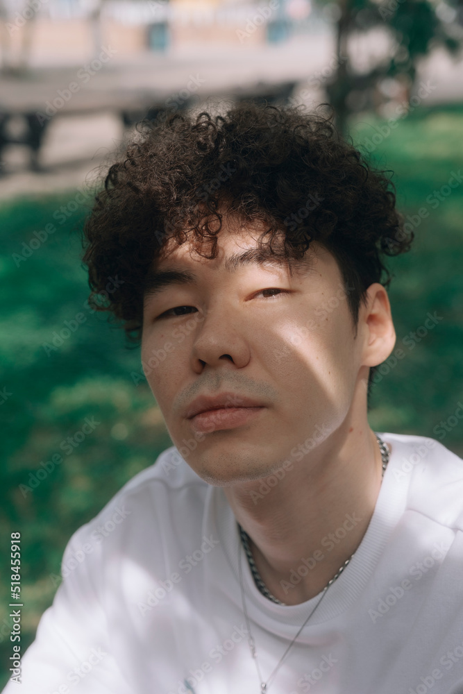 Portrait of a young curly-haired Asian man Portrait of a young curly-haired Asian man