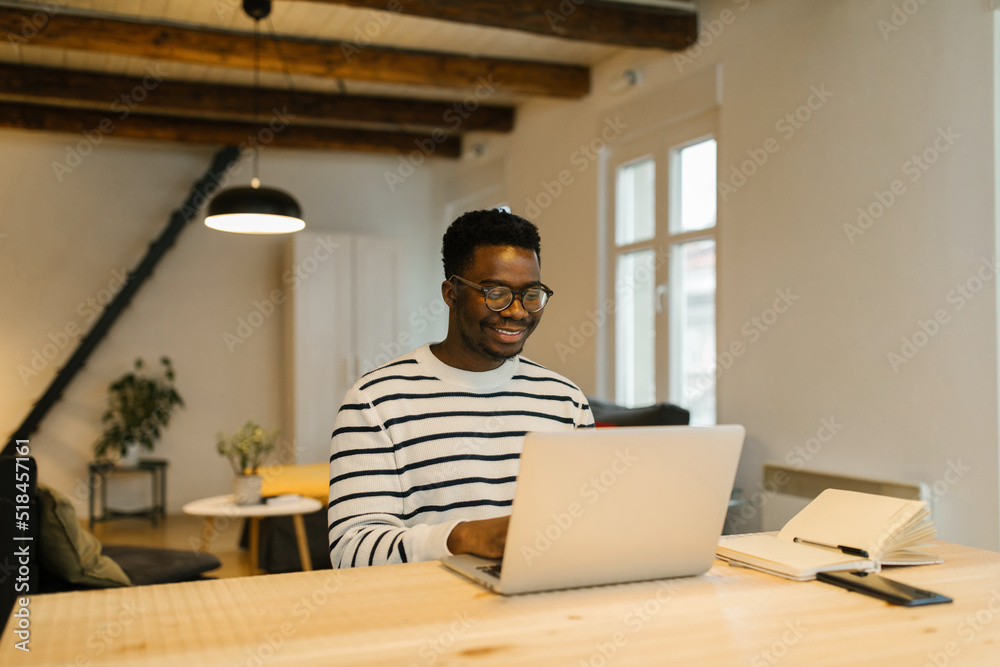 Smiling man having online meeting via computer Smiling man having online meeting via computer
